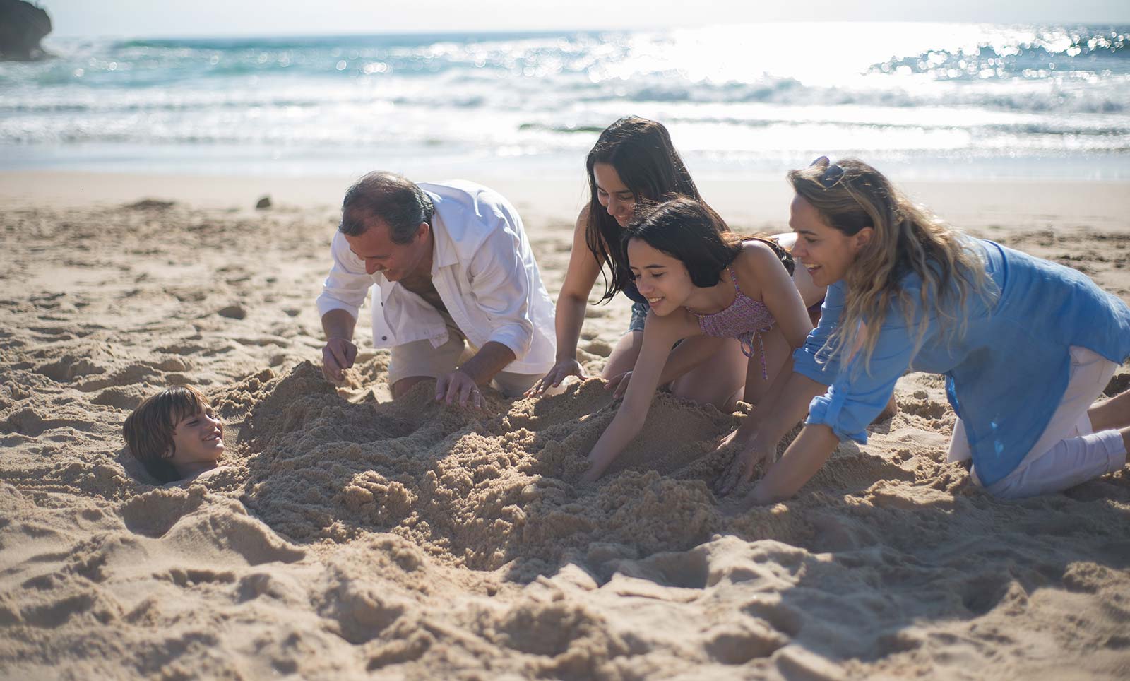 Family on the sand of a beach near the campsite in Oléron