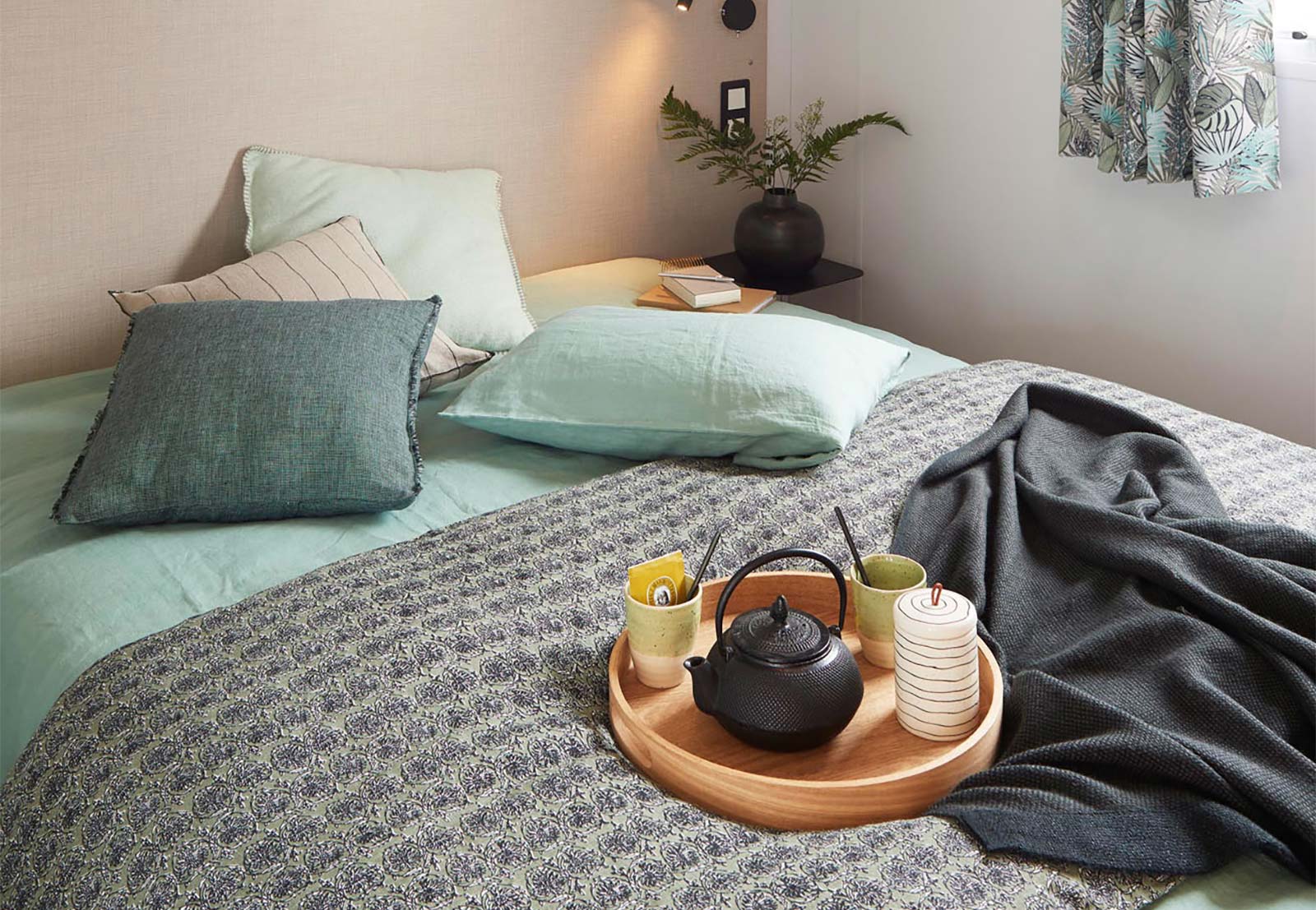 Bed with breakfast tray in the master bedroom of a mobile home in Oléron