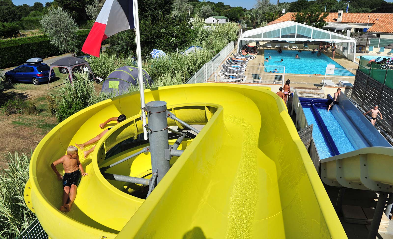 Yellow water slide in the aquatic area of the campsite in Oléron