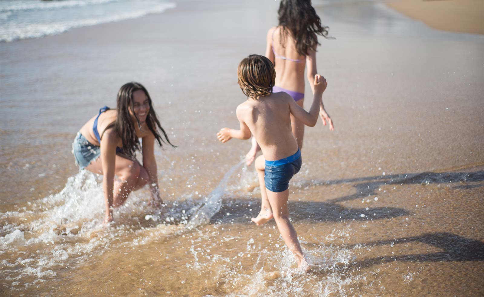 Children playing in the water on a beach in Oléron