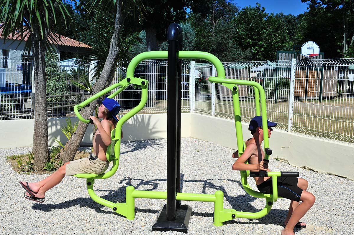 Campeurs faisant de la musculation en plein-air au camping à Oléron